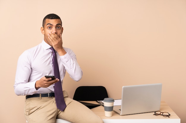 Young business man in a office with surprise facial expression