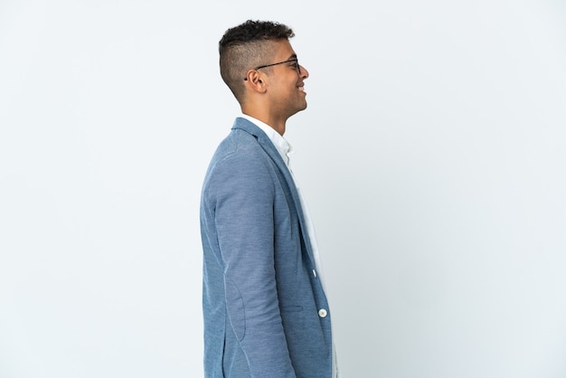 Young business man posing isolated against the blank wall
