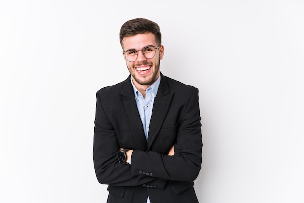 Young business man posing in a white wall isolated Young caucasian business man laughing and having fun