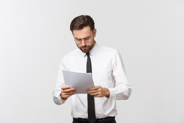 Young business man serious writing on clipboard, Handsome businessman wear elegant suit and tie isolated over white space