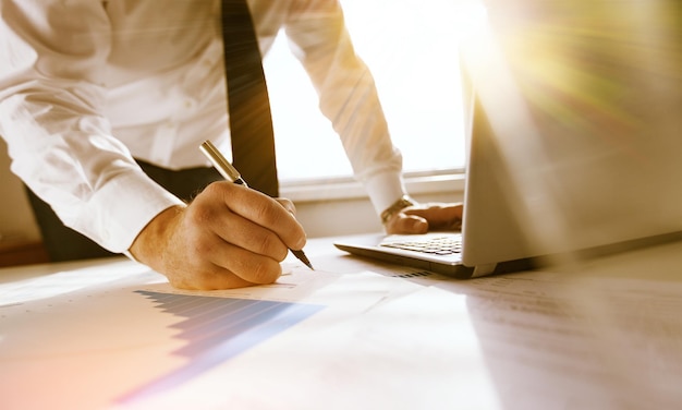 Young business man in suit working with laptop