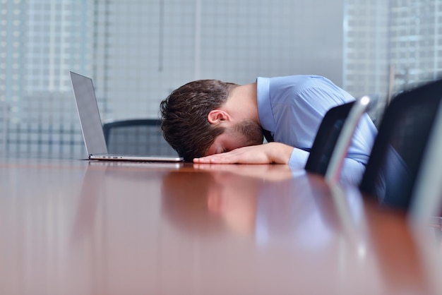 Young business man with problems and stress in the office