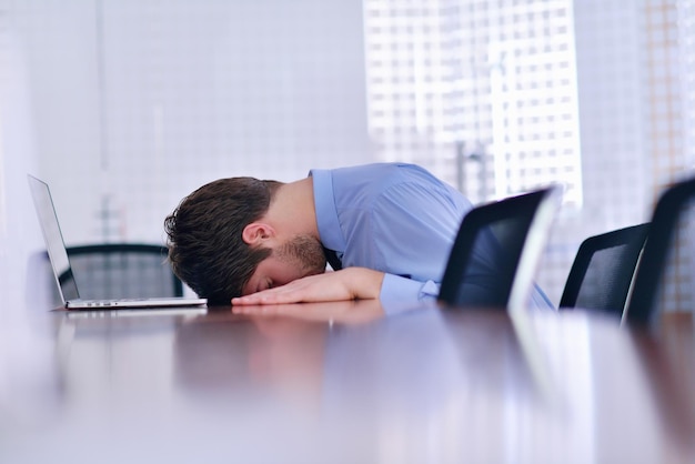 Young business man with problems and stress in the office