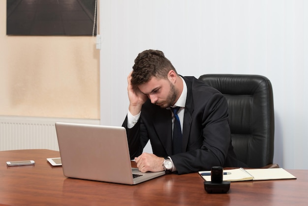 Young Business Man With Problems And Stress In The Office