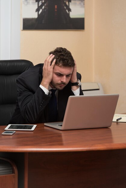 Young Business Man With Problems And Stress In The Office