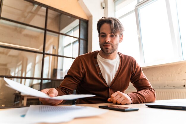 Young business man working in the office. Start up employer sitting at his workstation