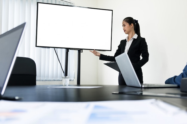 young business man working presentation using television computer of the blank screen