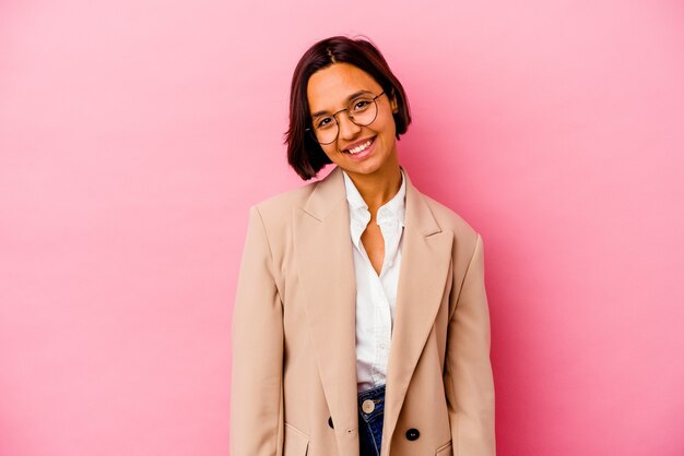 Young business mixed race woman isolated on pink background happy, smiling and cheerful.