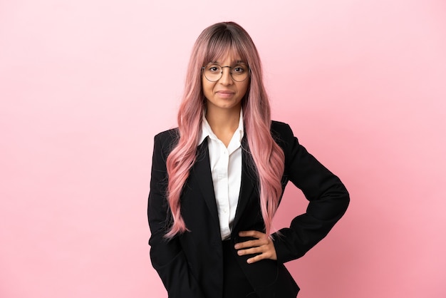 Young business mixed race woman with pink hair isolated on pink background laughing