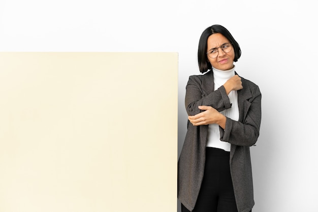 Young business mixed race woman with with a big banner over isolated background with pain in elbow