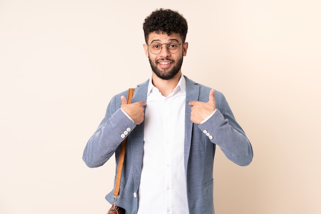 Young business Moroccan man isolated on beige wall with surprise facial expression