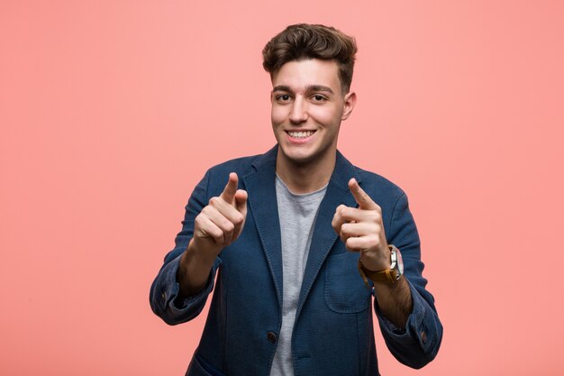 Young business natural man cheerful smiles pointing to front.