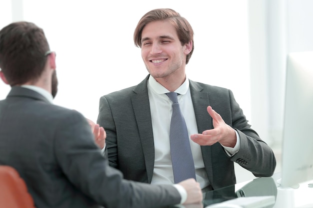 Young business partners shake hands