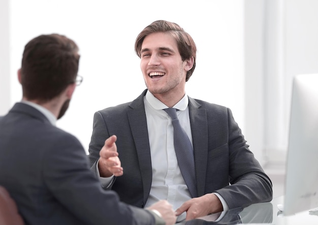 Young business partners shake hands