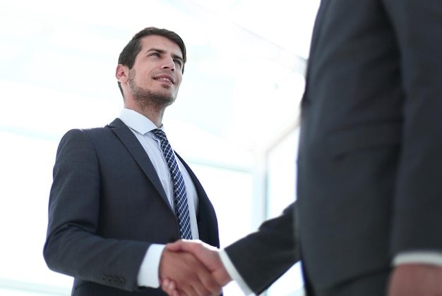 Young business partners shaking hands