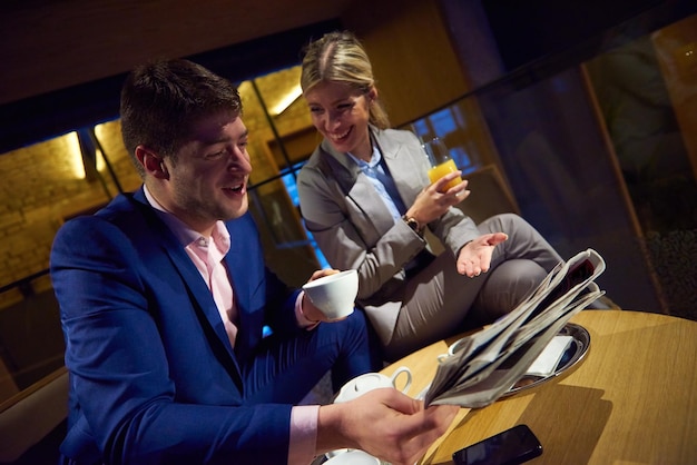 young business people couple relaxing after work in bar restaurant and take drink