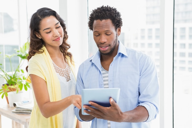 Young business people holding and using a digital tablet