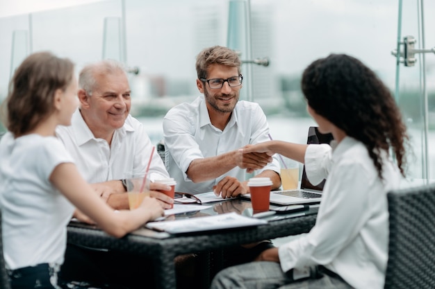 Young business people shaking hands at a meeting in a business center