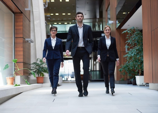 young business people team walking, group of people on modern office hall interior