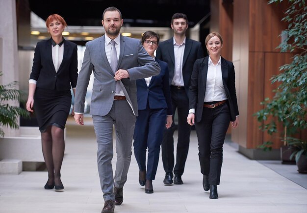 young business people team walking, group of people on modern office hall interior