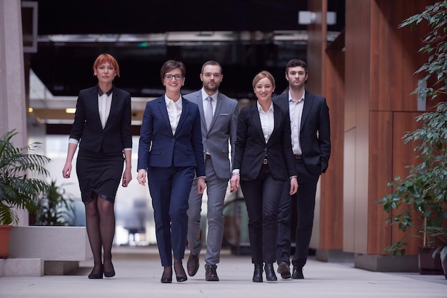 young business people team walking, group of people on modern office hall interior