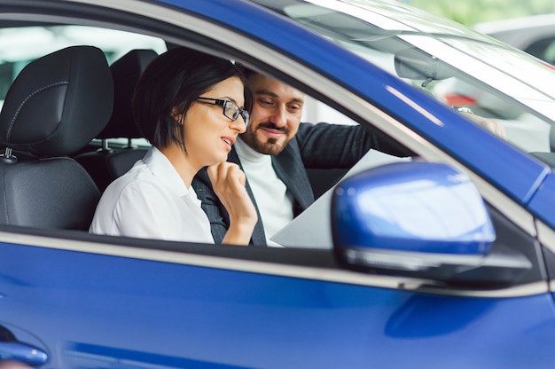 Young business people working together while traveling by a car.