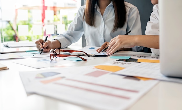 young business people working with paperwork together in modern office