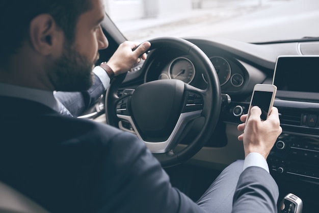 Young business person test drive new vehicle using digital device