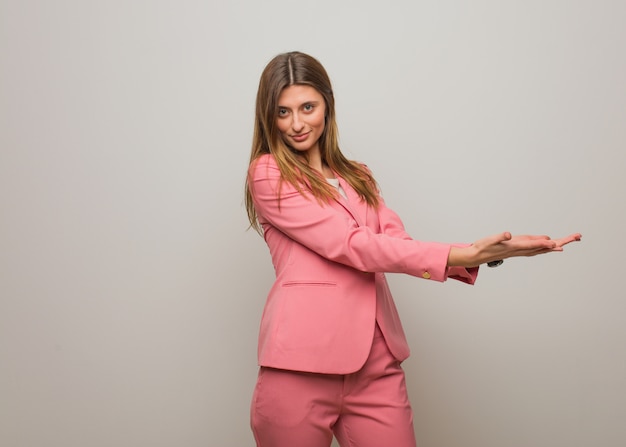 Young business russian girl holding something with hands