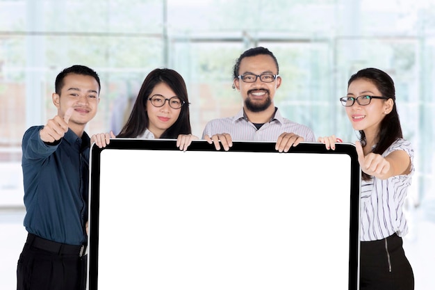 Young business team holding placard