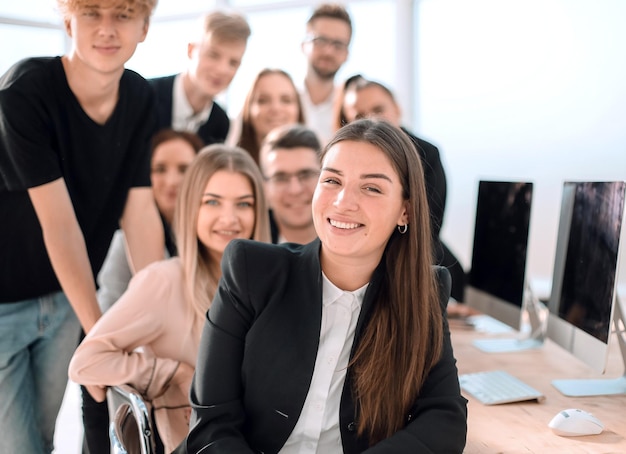 Young business woman on the background of her colleagues