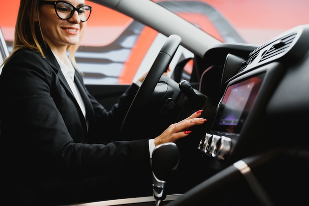 Young business woman driving in her car to work.