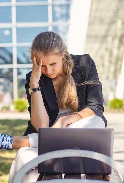 A Young business woman hard working at park