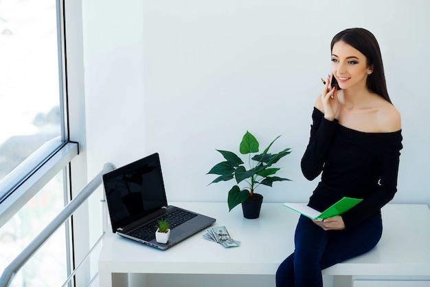 Young Business Woman Holding in Hands Phone