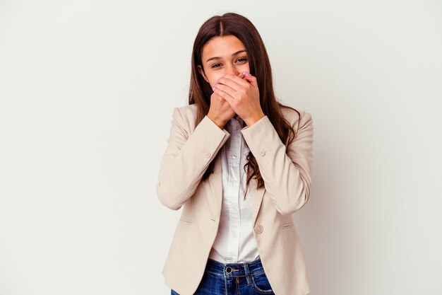 Young business woman isolated on white wall shocked covering mouth with hands