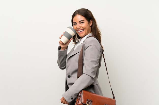 Young business woman over isolated white wall