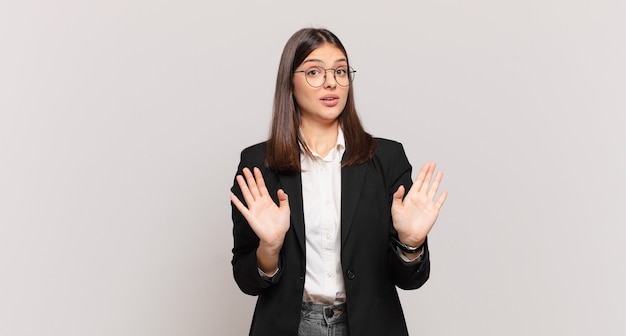 Young business woman looking nervous, anxious and concerned, saying not my fault or I didnÃÂ¢ÃÂÃÂt do it