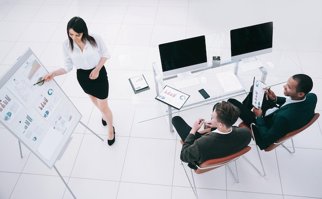 Young business woman making a presentation to his business team