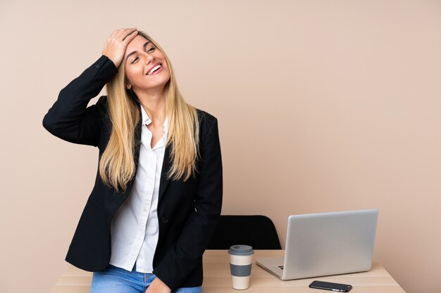 Young business woman in a office laughing