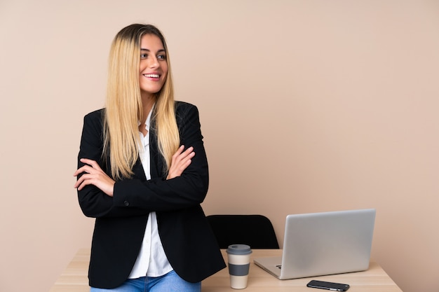 Young business woman in a office laughing