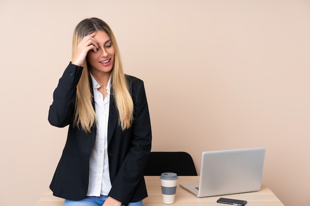 Young business woman in a office laughing