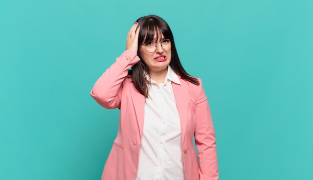 Young business woman panicking over a forgotten deadline, feeling stressed, having to cover up a mess or mistake