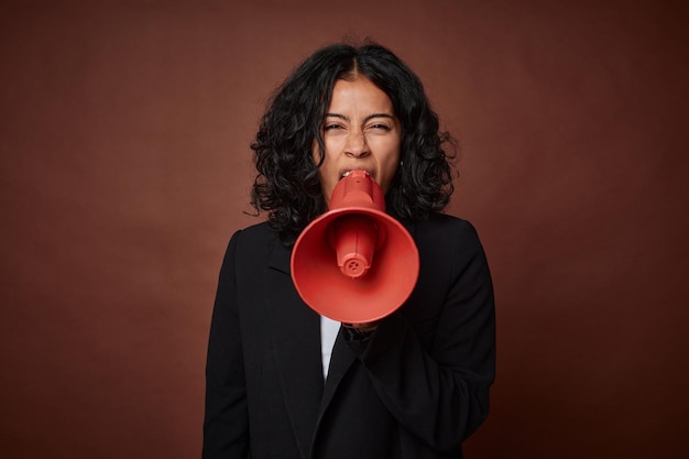 A young business woman passionately advocates for her rights with a megaphone