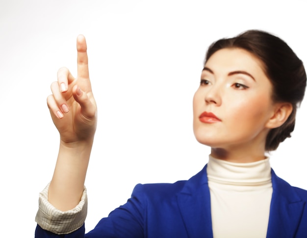 Young business woman pointing her finger on imaginery virtual button