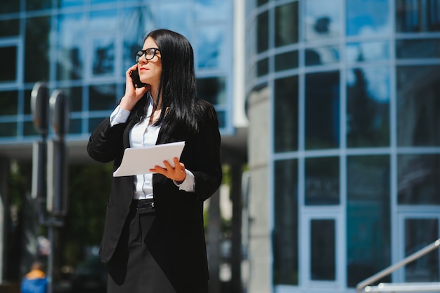 Young business woman portrait near office building