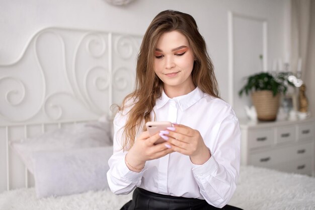 A young business woman reads the news or sends a text message