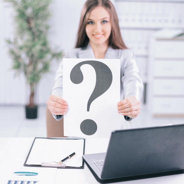 Young business woman showing a question mark