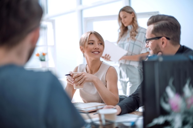 Young business woman sitting at office Desk