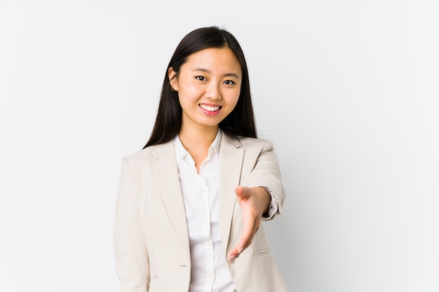 Young business woman stretching hand at camera in greeting gesture.