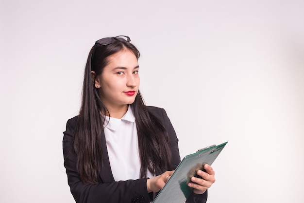 Young business woman wearing glasses, holding paper folder on white